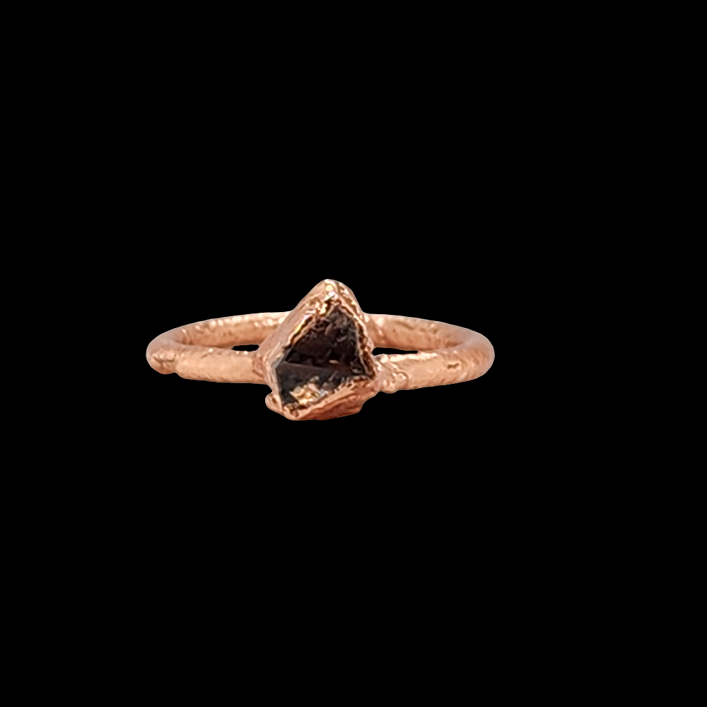 Close up of a mostly triangular shaped herkimer diamond ring encapsulated in copper.