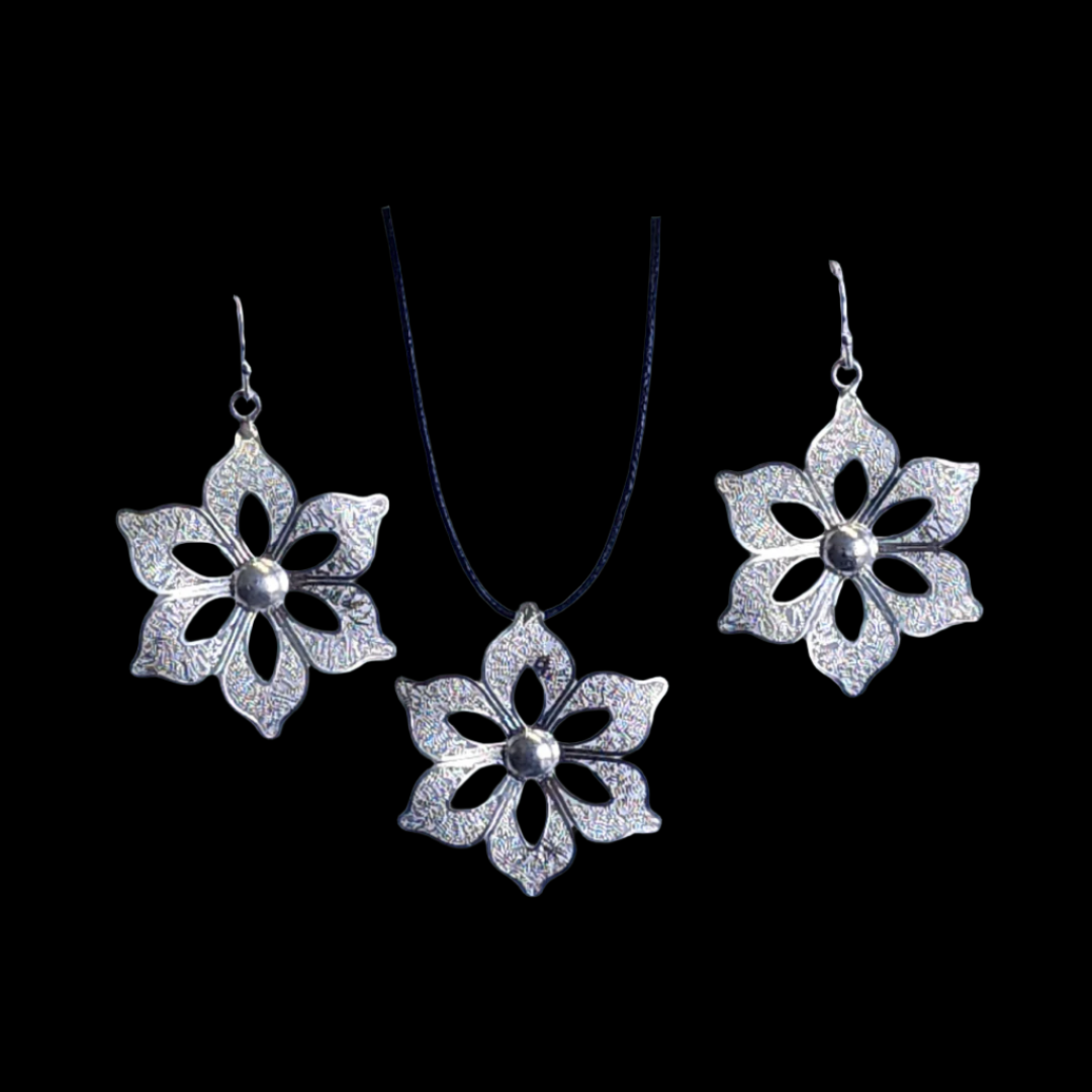 Jewelry set featuring silver-toned floral dangle earrings and a matching flower-shaped pendant on a black cord, each with petal cutouts and a polished central bead.