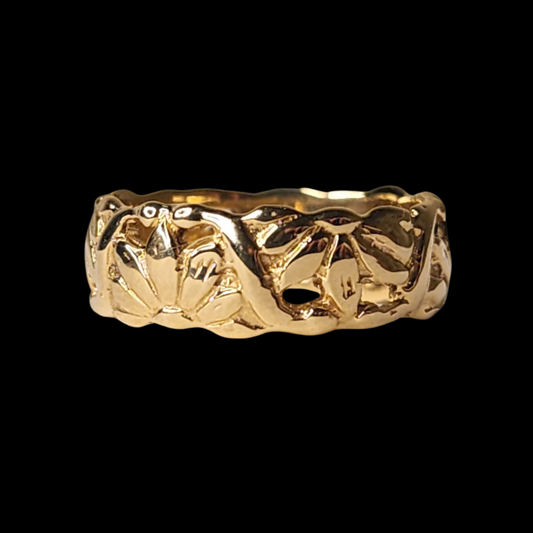 A gold ring with a textured floral pattern engraved around its surface, displayed on a black background
