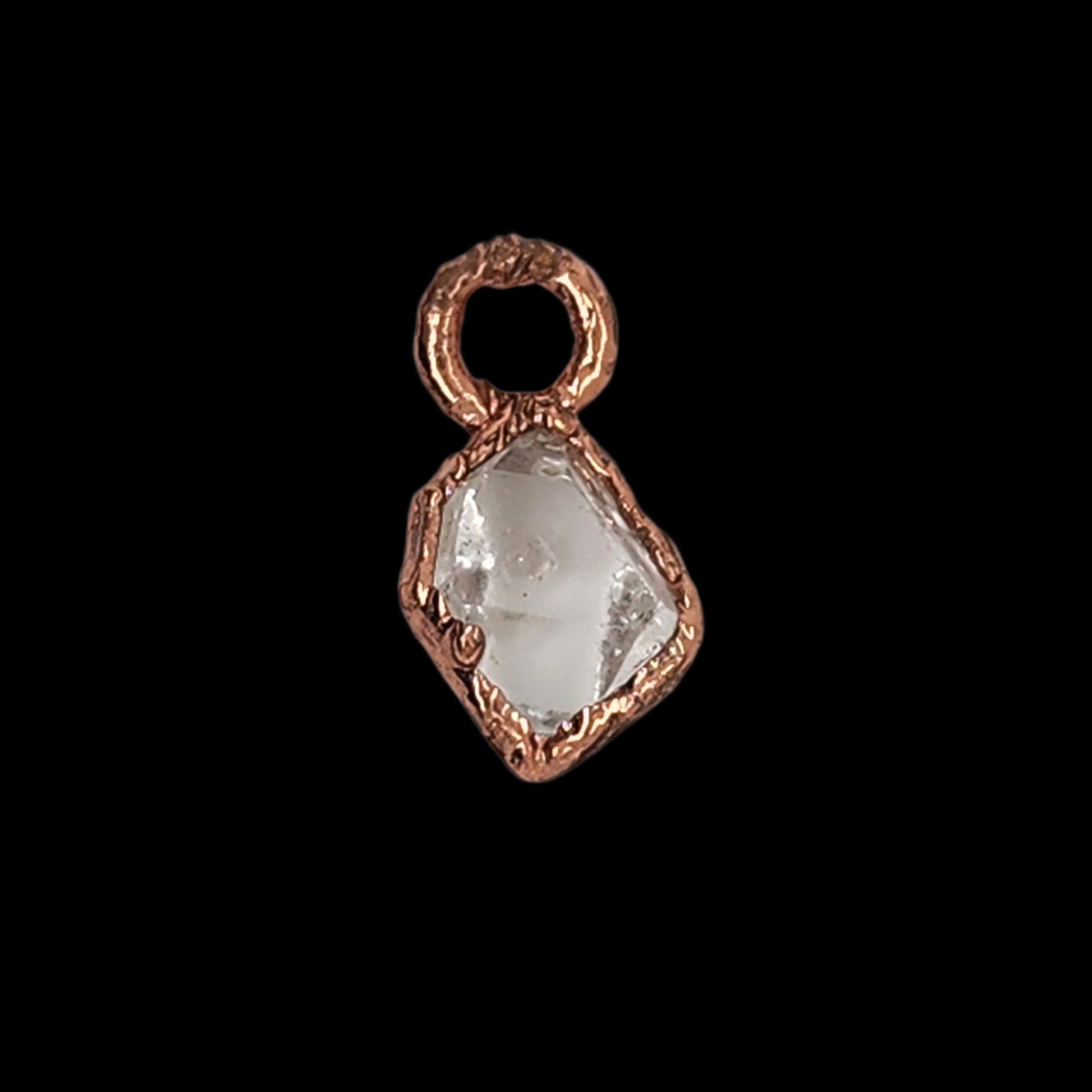 Front view of a copper pendant with a faceted raw crystal gemstone, showing the intricate copper texture and the gemstone’s clear brilliance.