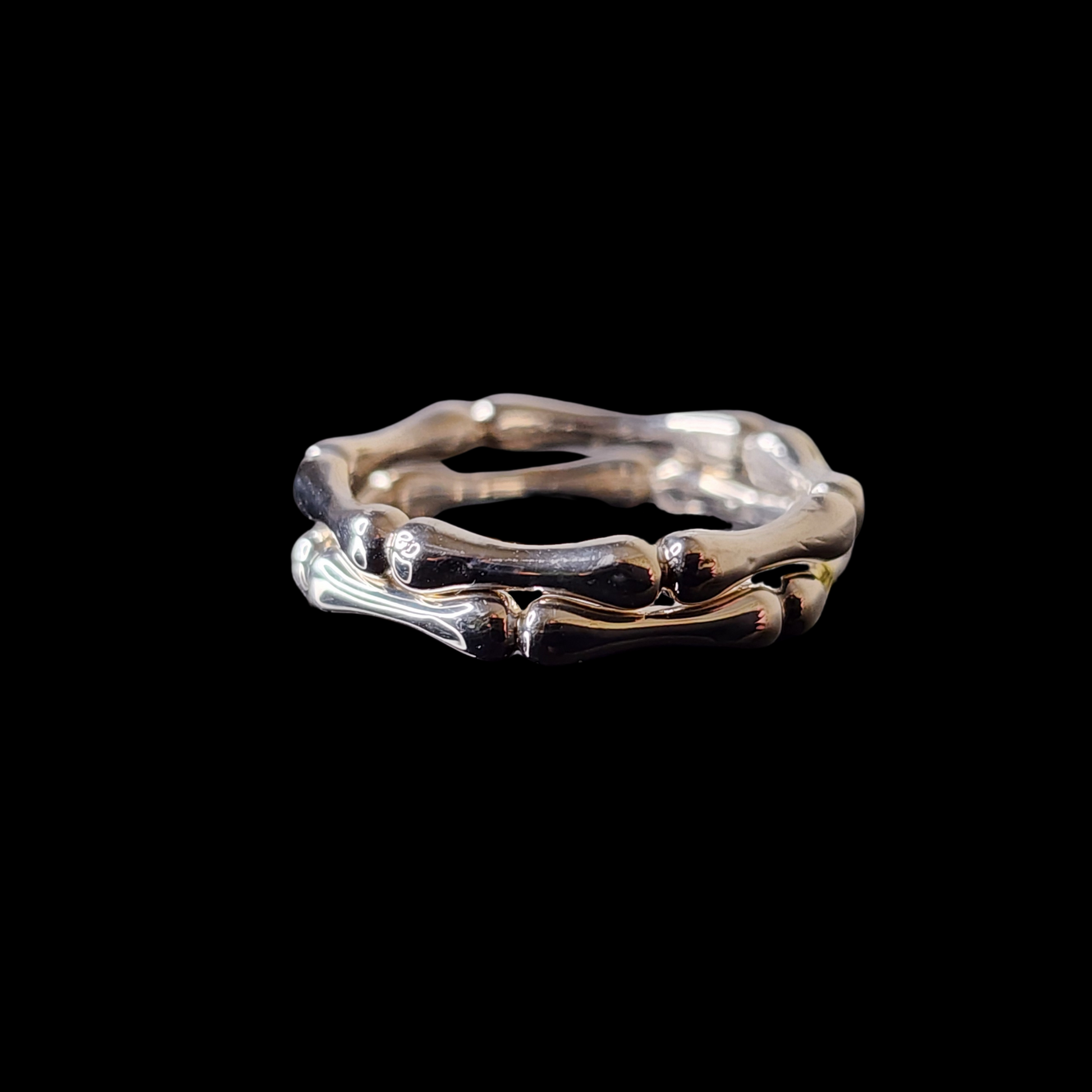 2 bones rings stacked on top of one another on a black background