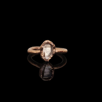 Handcrafted copper ring featuring a raw Herkimer diamond gemstone, showcasing its natural quartz beauty on a black background.